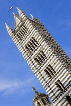 ITALY, Tuscany, Siena, The belltower of the Gothic Duomo or Cathedral church of Santa Maria Assunta made from local white and greenish black marble. Black and white are the colours of the city.