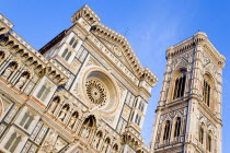 ITALY, Tuscany, Florence, The Neo-Gothic marble west facade of the Cathedral church of Santa Maria del Fiore, the Duomo, and Giotto's Campanile bell tower at sunset.