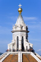 ITALY, Tuscany, Florence, The dome of the Cathedral of Santa Maria del Fiore, the Duomo, by Brunelleschi with tourists on the viewing platform looking over the city towards the surrounding hills.