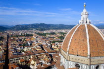 ITALY, Tuscany, Florence, The Dome of the Cathedral of Santa Maria del Fiore, the Duomo, by Brunelleschi with tourists on the viewing platform looking over the city towards the surrounding hills.