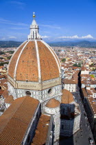 ITALY, Tuscany, Florence, The Dome of the Cathedral of Santa Maria del Fiore, the Duomo, by Brunelleschi with tourists on the viewing platform looking over the city towards the surrounding hills.