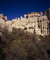 Ille Sur Tet.  Sandstone area known as Orgues.  Eroded sandstone cliff rising above vegetation.