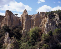 Ille Sur Tet.  Sandstone area known as Orgues.  Eroded pinnacles of sandstone rock rising above trees.