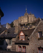 The Abbey on hilltop above tiled rooftops of town houses from the Archade Tower.