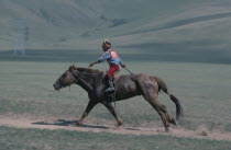 Child jockey  competing in National Day horse race.