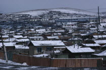 Snow covered rooftops of housing in city suburbs in winter.