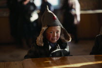 Child in shop wearing hat with long ear flaps