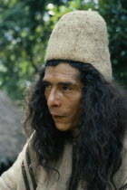 Portrait of Ika man wearing traditional woven wool and cotton cloak and finely woven fique cactus helmet.Arhuaco Aruaco indigenous tribe American Classic Classical Colombian Columbia Hispanic Histori...