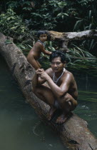 Barasana father Pacico and his son stand on log at river port. Tukano sedentary Indian tribe North Western Amazonia family American Colombian Columbia Dad Hispanic Indegent Kids Latin America Latino...