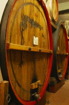 Bardolino.  Large wooden wine casks in cellar at the Museum of Wine.  Barrel in foreground labelled as containing Valpolicella.