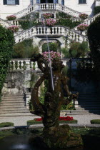 Villa Carlotta eighteenth century summer-house near Tremezzo.  Fountain and gardens in foreground with steps to tiered balconies leading to villa behind.