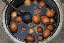 China, Beijing, pickled eggs in bowl with ladle.