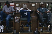 Shoe shiners relaxing in their chairs