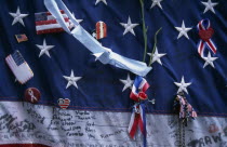 Close up detail of September 11th memorial with decorated stars and stripes flag