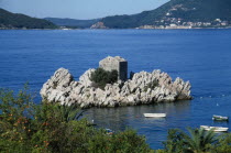 Fortified building built into rock formation off the coast