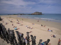 Le Sillon Beach and Fort National. Sunbathers on golden sand