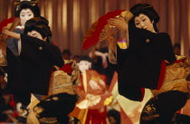 Geisha performing dance with fans during stage show held in the spring for the public.