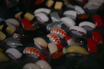 Colourful window display of plastic sushi.