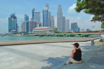 THE FULLERTON HOTEL AND FIANANCIAL DISTRICT OF SINGAPORE CITY SEEN FROM ACROSS THE ESPLANADE DRIVE DRIVE BRIDGE FROM THE ESPLANADE MALLAntipodean Oceania One individual Solo Lone Solitary Shopping Ce...