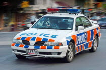 QUEENSTOWN  A NEW ZEALAND POLICE CAR AND OFFICER SPEEDS PAST ALONG SHOTOVER STREET  QUEENSTOWN.Antipodean Oceania Automobile Automotive Cars Motorcar