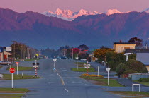 HOKITIKA  DUSK LOOKING THE LENGTH OF PARK STREET EAST INLAND TOWARDS THE SOUTHERN ALPS FROM THE HOKITIKA COAST ROAD.Antipodean Oceania Scenic