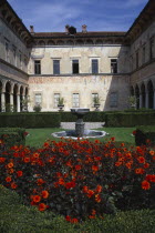 Villa Cicogna Mozzoni east of Lake Maggiore.  Exterior of Renaissance villa built between 1400 -1500 by the Mozzoni family.  Water feature and dahlias in foreground.