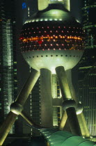 Part view of the Oriental Pearl Tower exterior illuminated at night.