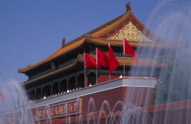 Fountains and entrance gateway to the Forbidden City with red flags and red and gold decorated  tile pavilion-style rooftop .  Asia Asian Chinese Chungkuo History Jhongguo Peking Zhonggu Beijing Jho...