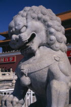 Stone statue of lion at entrance gateway to the Forbidden City from Tiananmen Square.