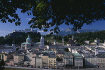 City view from Hettwerr Bastion  part of the old city walls on Kapuzinerberg Hill.  Part framed by tree branches.