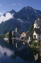 View over lakeside buildings with mountain backdrop.