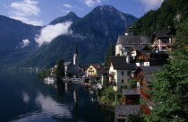 View over lakeside buildings with mountain backdrop.