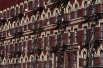 Greenwich Village.  Houses on 7th Avenue  red brick exteriors with cream coloured architectural detail and decorative metal fire escapes.