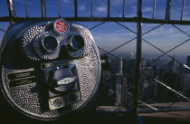 View north over city  from top of the Empire State Building with coin operated tourist binocular telescope in foreground.