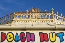 Beach hut sign above shop at the promenade end of the former West Pier.