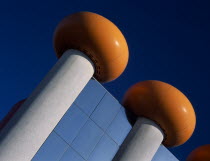 The Circus Building amusement arcade and cinema complex. Detail of modern roof with doughnut shaped orange rings against a blue sky