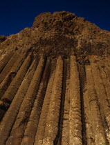 The section known as The Organ. Pillars of rock in cliff-face which resemble a pipe organ seen in golden light.