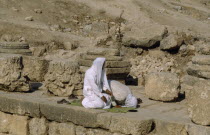 Two muslim men pray towrds Mecca.