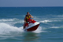 Person on a red jet ski in action