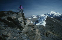 Cyclist with mountain bike on Chacultay snow mountain peak in Boliva