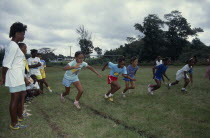 Children competing in running race during school sports day.