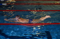 Man in swimming pool performing Breaststroke