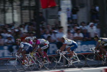 Tour de France cyclists racing through the streets of Paris   France.