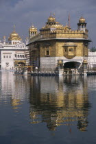 Golden Temple reflected in surrounding pool.Asia Asian Bharat History Inde Indian Intiya Religion Religious