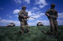 Soldiers on military exercise with warrior tanks.