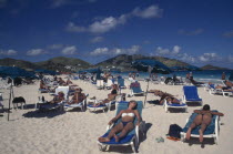 Orient beach with people sunbathing on loungersBeaches Caribbean Holidaymakers Resort Sand Sandy Seaside Shore Sunbather Tourism Tourist Tourists Travel West Indies