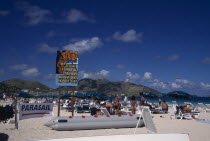 Orient beach with people sunbathing on loungersBeaches Caribbean Holidaymakers Resort Sand Sandy Seaside Shore Sunbather Tourism Tourist Tourists Travel West Indies