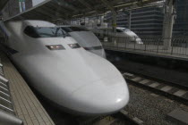 Tokyo Station  three white bullet trains at the platform  nozumi shinkansen  left and hikari shinkansen  right.Asia Asian Japanese Nihon Nippon 3