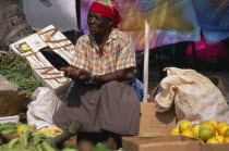 Woman stallholder in fruit and vegetable market.Female Women Girl Lady One individual Solo Lone Solitary West Indies