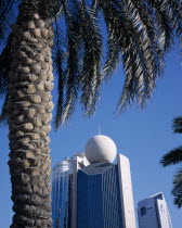 Etisalat Building on Dubai Creek with palm tree in foreground.Dubayy United Arab Emirates Al-Imarat Al-Arabiyyah Al-Muttahidah Arabic Emiriti Middle East